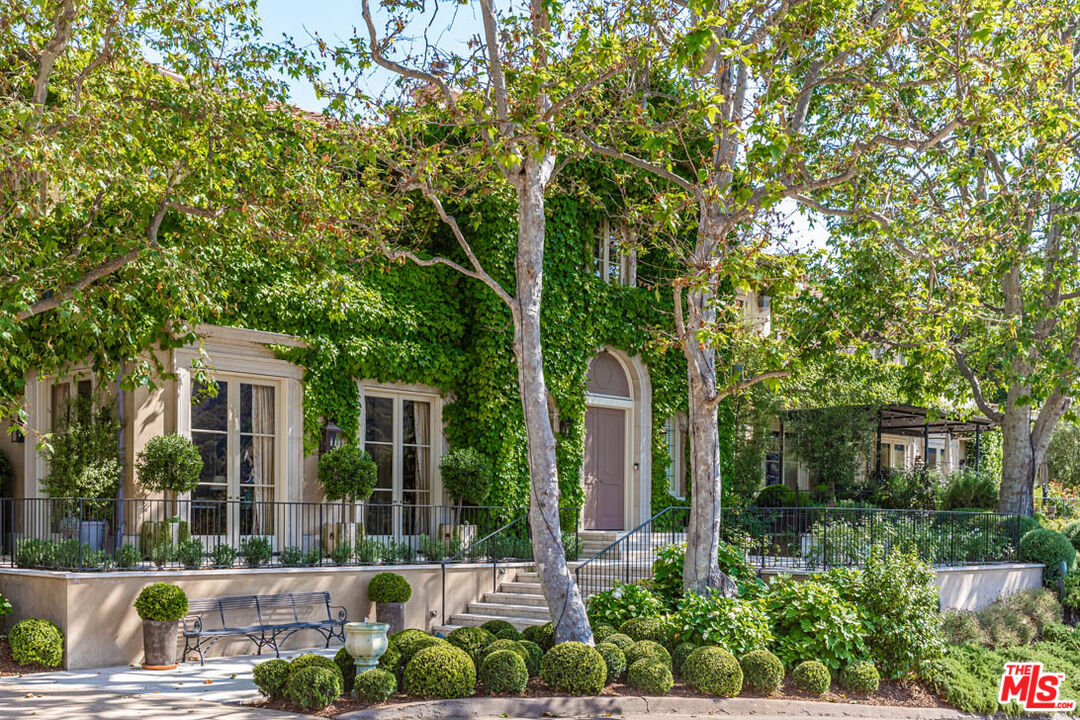 10702 Levico Way Los Angeles, CA 90077 - Photo 7 of 35 a front view of a house with garden