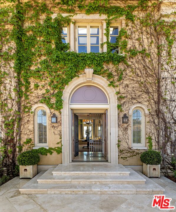 10702 Levico Way Los Angeles, CA 90077 - Photo 8 of 35 a front view of a house with a garden