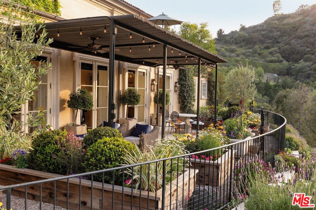10702 Levico Way Los Angeles, CA 90077 - Photo 9 of 35 a view of a balcony with chairs and wooden fence