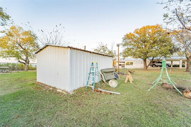 a view of a backyard with table and chairs