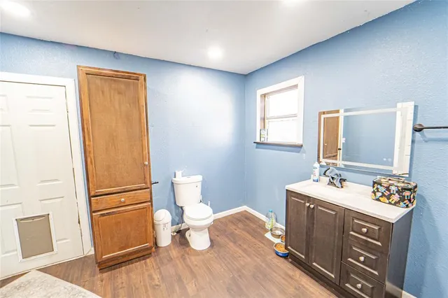 a bathroom with a sink a toilet and mirror