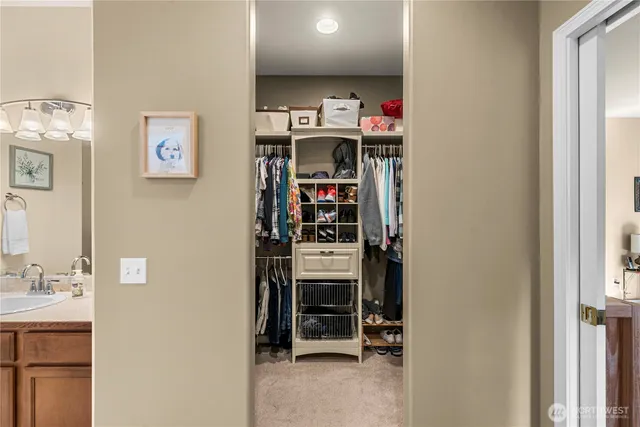 a view of a bedroom with a bed and a window