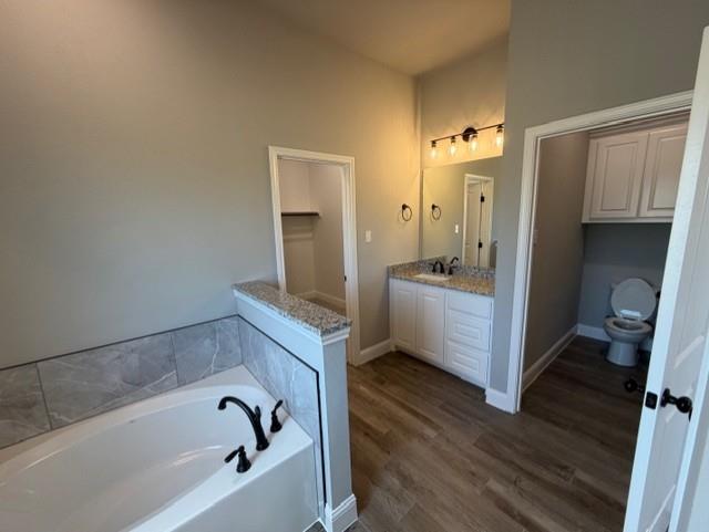 202 Coalson Crossing Azle, TX 76020 - Photo 15 of 23 a bathroom with a tub sink toilet and a bathtub