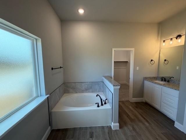 202 Coalson Crossing Azle, TX 76020 - Photo 18 of 23 a bathroom with a bathtub a sink and wooden floor