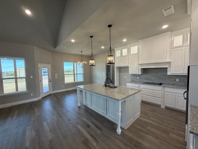 202 Coalson Crossing Azle, TX 76020 - Photo 8 of 23 a kitchen with stainless steel appliances granite countertop a stove a sink a refrigerator and white cabinets with wooden floor