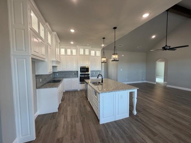 202 Coalson Crossing Azle, TX 76020 - Photo 9 of 23 a large kitchen with stainless steel appliances a large counter top a wooden floors and a large window