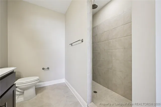 a white toilet sitting next to a bath tub