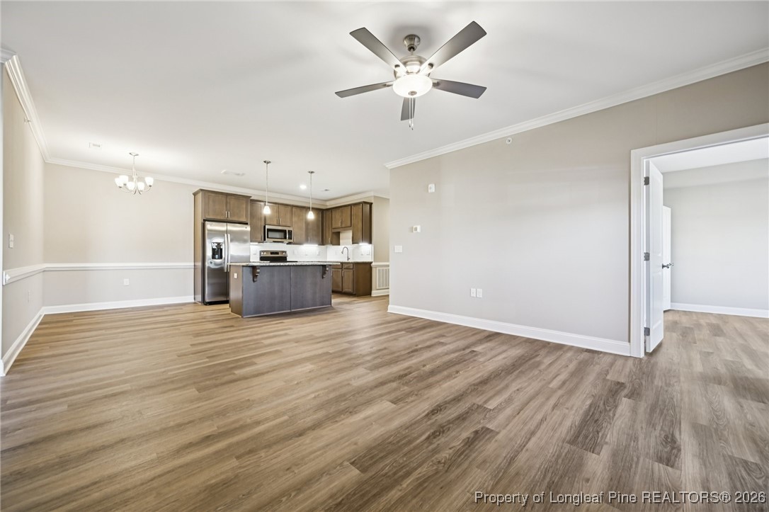 240 Gallery Drive, Unit 301 Spring Lake, NC 28390 - Photo 5 of 22 a view of a kitchen with a stove cabinets and wooden floor