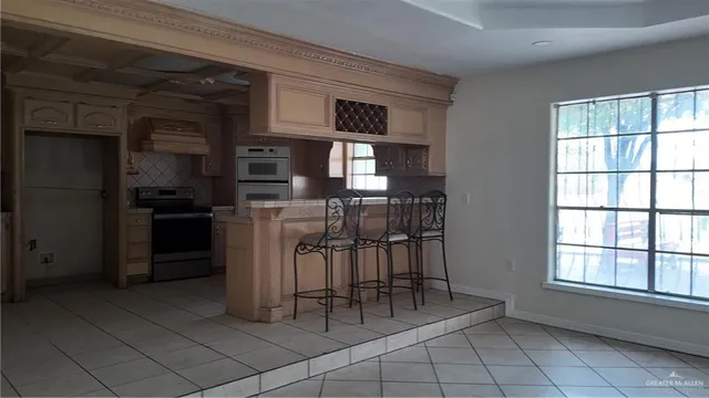 a kitchen with white cabinets and appliances