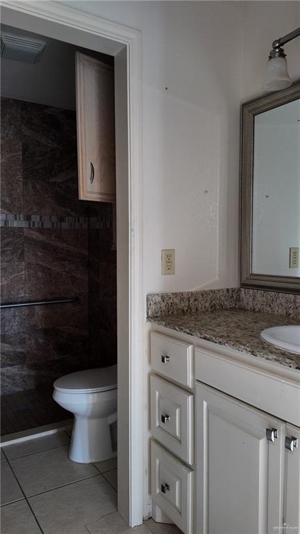 612 West Ramirez Street Rio Grande City, TX 78582 - Photo 23 of 40 a bathroom with a granite countertop toilet a sink and a mirror