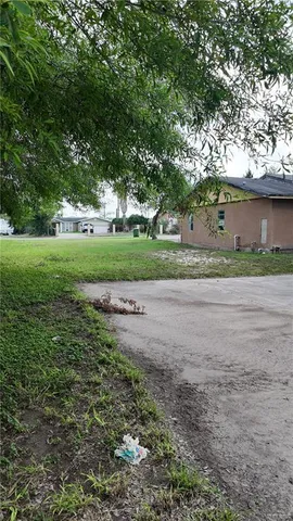 a view of a dirt road and a building in the background