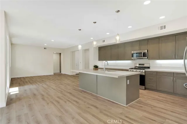 a kitchen with stainless steel appliances granite countertop a sink and stove top oven