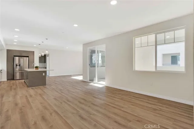 a view of a kitchen with wooden floor and a kitchen