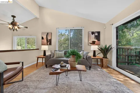 a living room with furniture a large window with outer view