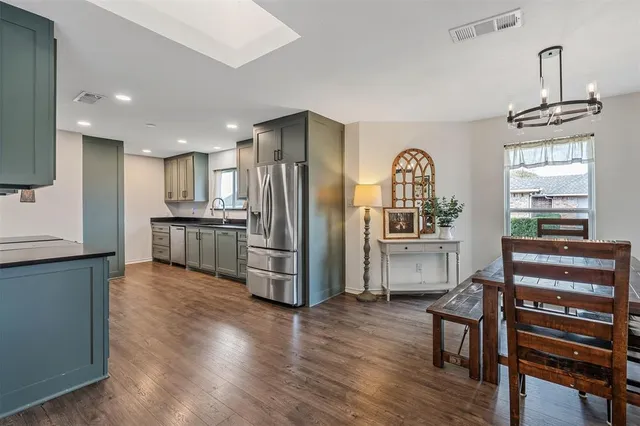 a kitchen with stainless steel appliances granite countertop a refrigerator and a stove top oven