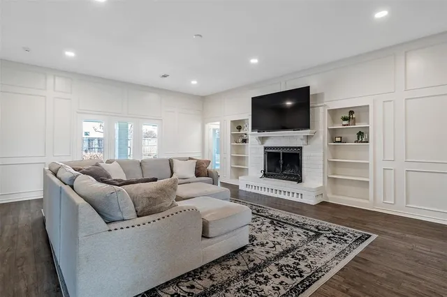 a living room with furniture flat screen tv and a fireplace