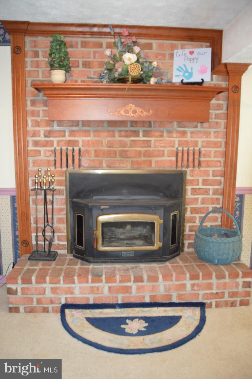 1454 B Warehime Road Westminster, MD 21158 - Photo 17 of 24 Brick Fireplace with wood stove insert