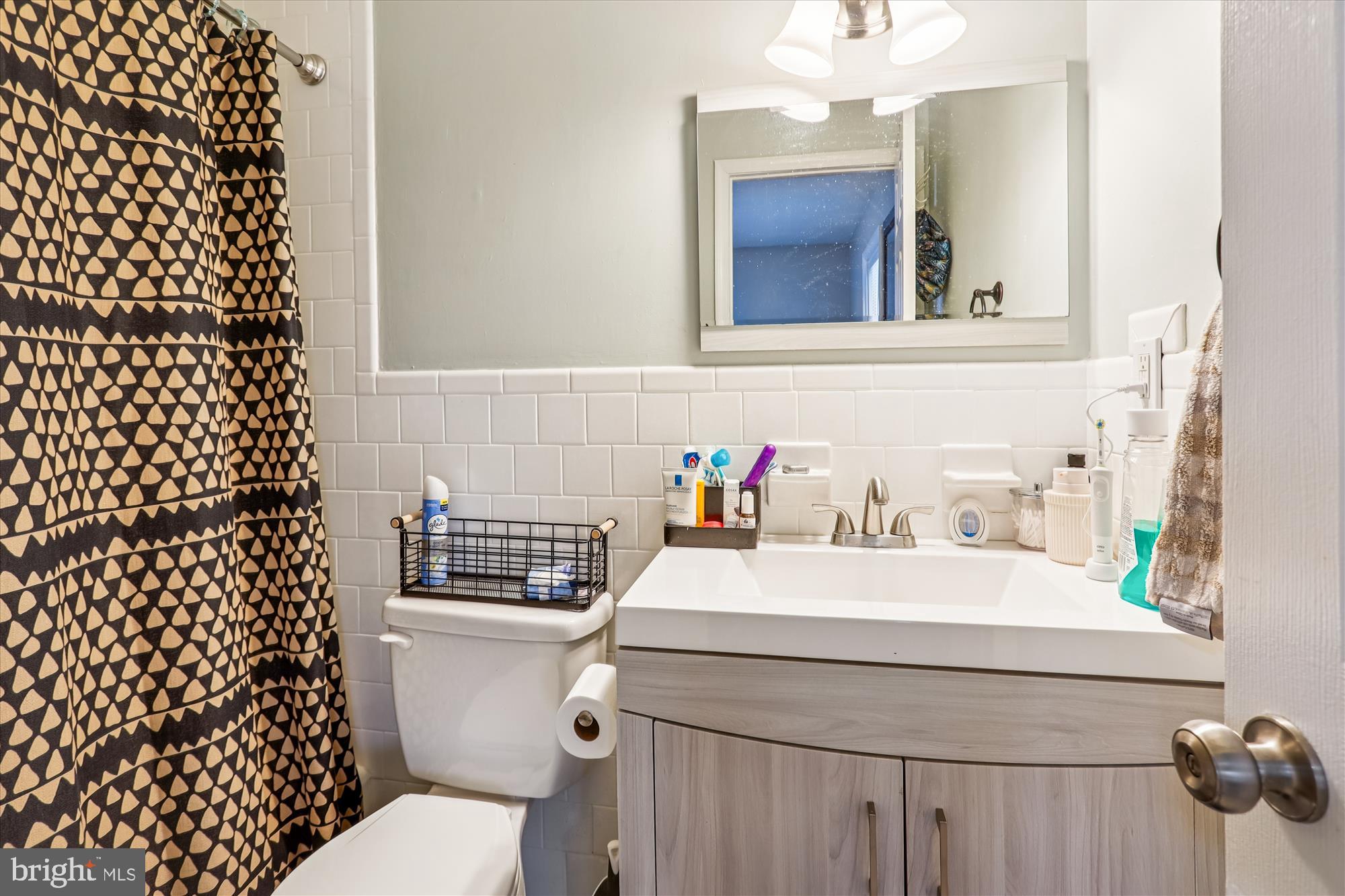 5706 Johnson Street Baltimore, MD 21225 - Photo 13 of 20 a bathroom with a sink and a mirror