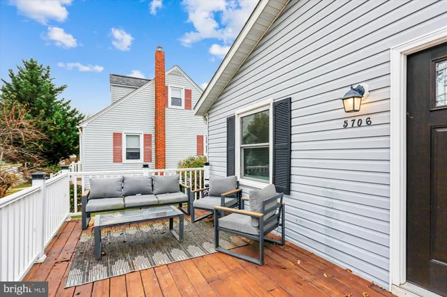 a balcony with furniture and wooden floor