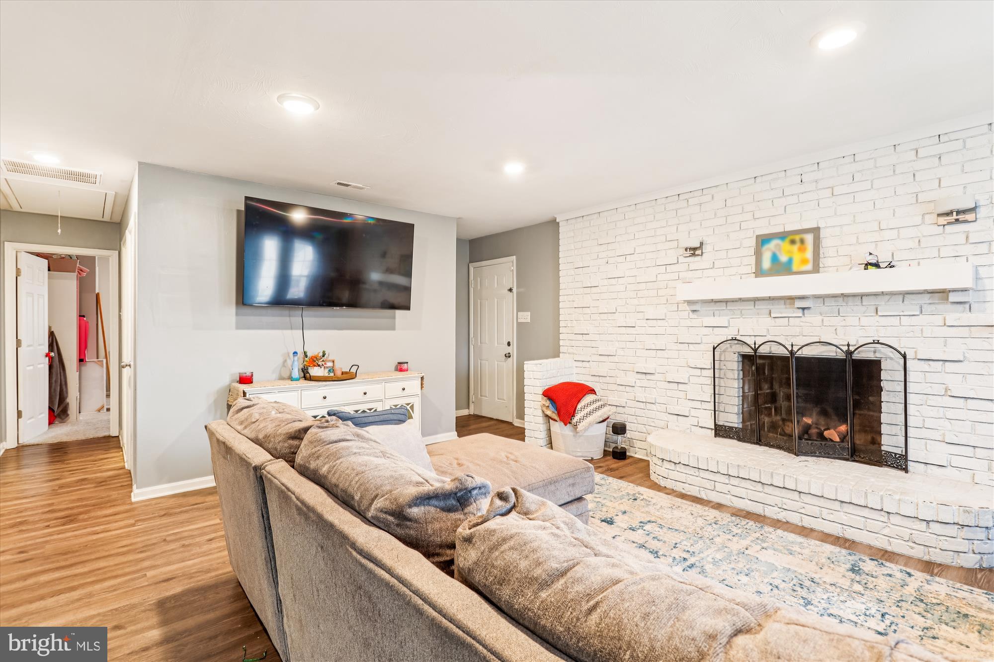 5706 Johnson Street Baltimore, MD 21225 - Photo 7 of 20 a living room with furniture and a flat screen tv