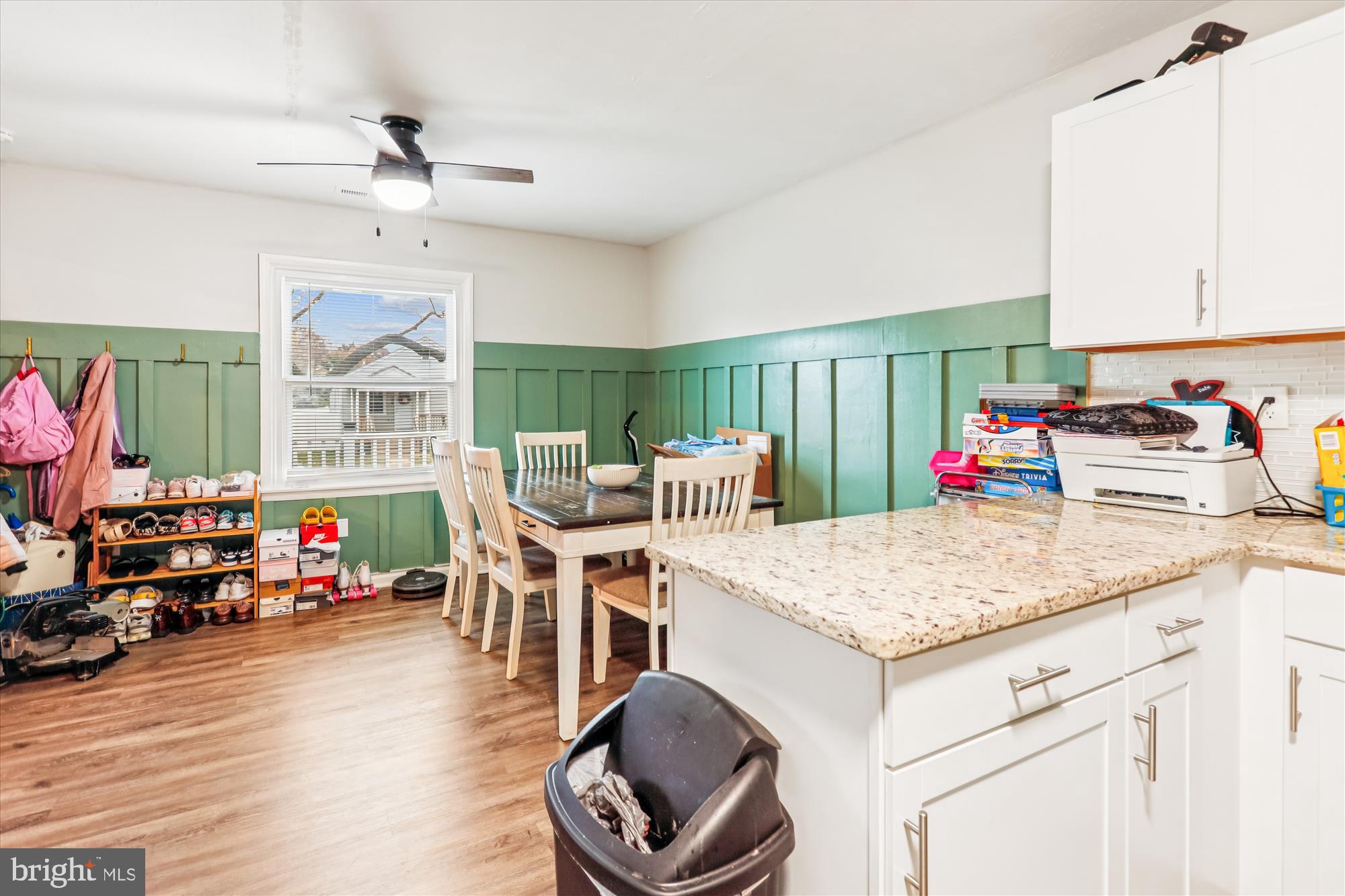 5706 Johnson Street Baltimore, MD 21225 - Photo 9 of 20 a kitchen with stainless steel appliances granite countertop a sink dishwasher and a dining table with wooden floor