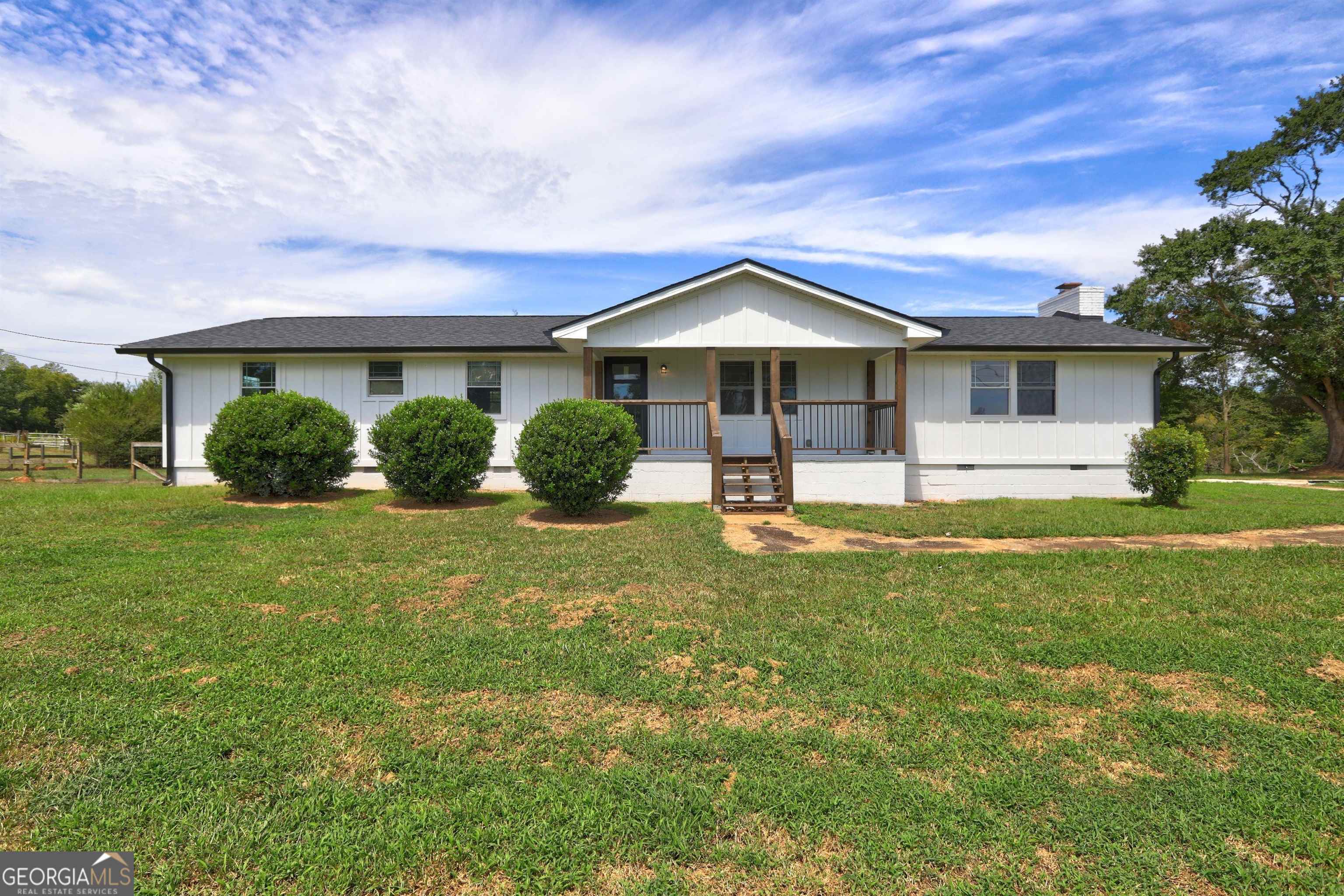a front view of house with yard and green space