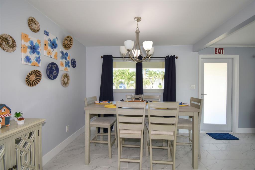 214 Southeast 5th Street Dania Beach, FL 33004 - Photo 13 of 50 a view of a dining room with furniture and wooden floor