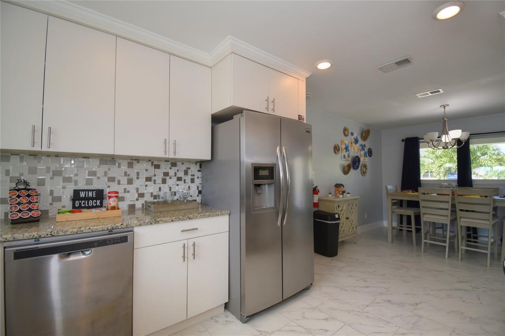 214 Southeast 5th Street Dania Beach, FL 33004 - Photo 17 of 50 a kitchen with refrigerator and cabinets