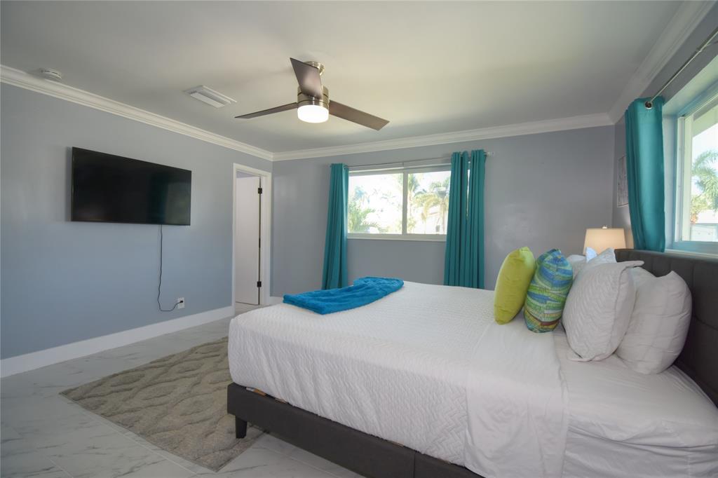 214 Southeast 5th Street Dania Beach, FL 33004 - Photo 29 of 50 a bedroom with a large bed and a television