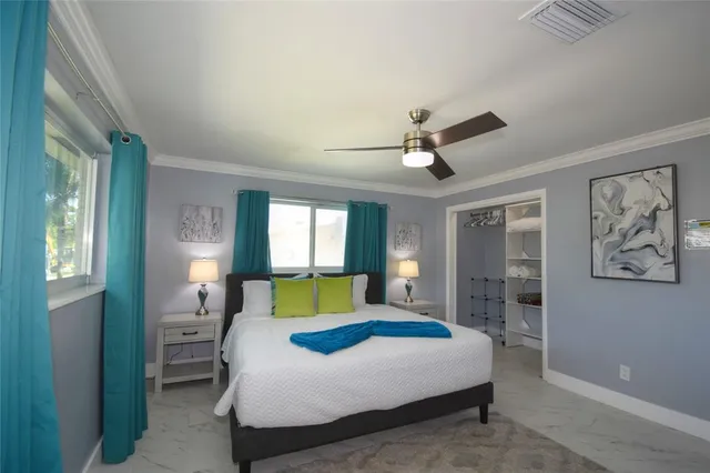 a bedroom with a large bed and a window