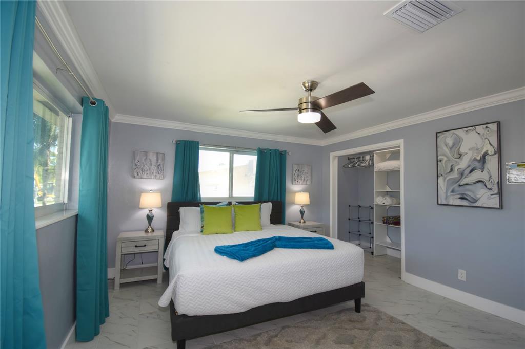 214 Southeast 5th Street Dania Beach, FL 33004 - Photo 31 of 50 a bedroom with a large bed and a window