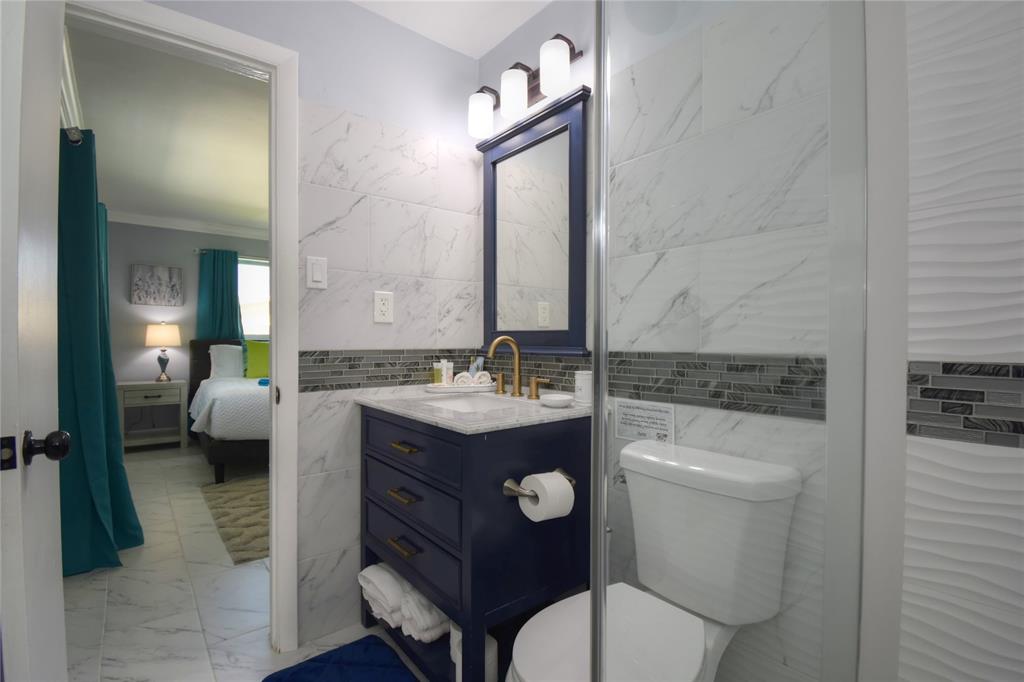 214 Southeast 5th Street Dania Beach, FL 33004 - Photo 33 of 50 a spacious bathroom with a toilet a sink and mirror