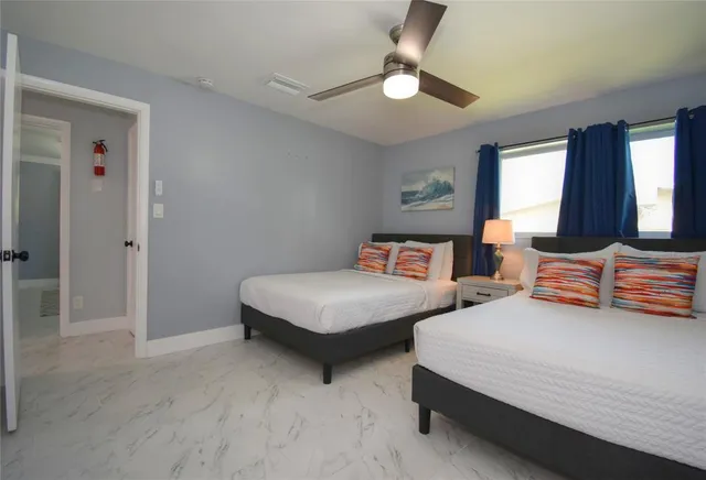 a bedroom with two beds and painting on the wall