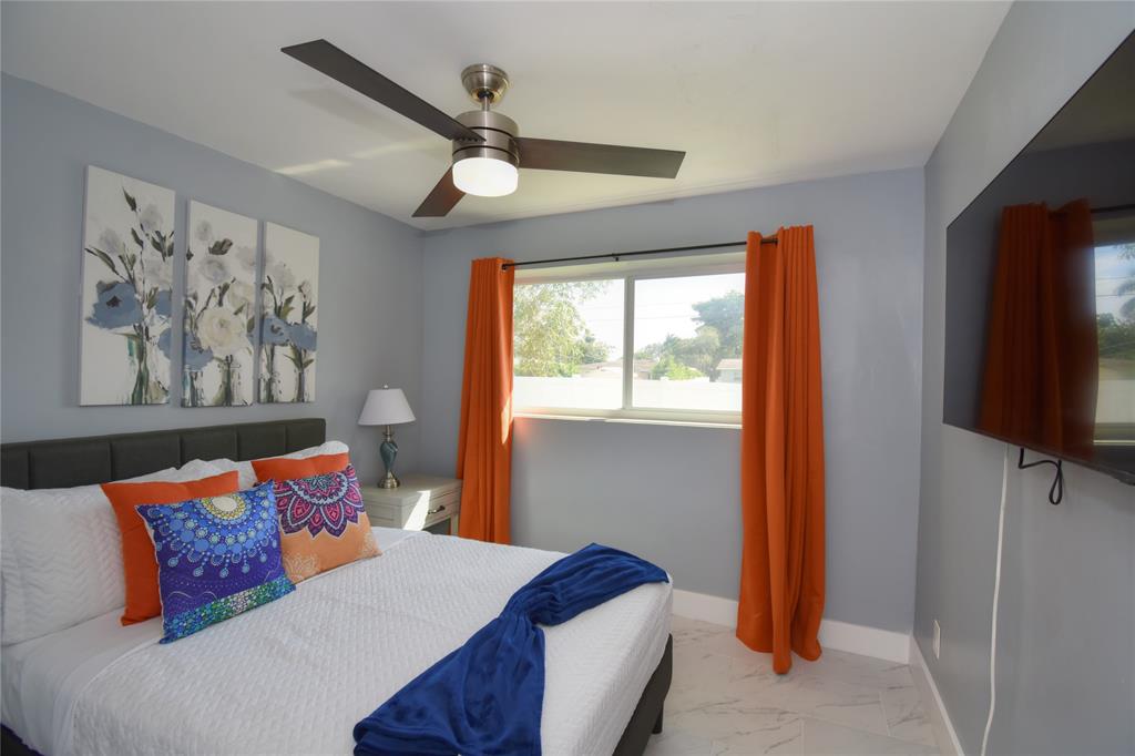 214 Southeast 5th Street Dania Beach, FL 33004 - Photo 39 of 50 a bedroom with a bed and a flat screen tv