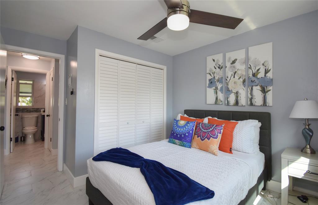 214 Southeast 5th Street Dania Beach, FL 33004 - Photo 41 of 50 a bedroom with a bed and a painting on the wall