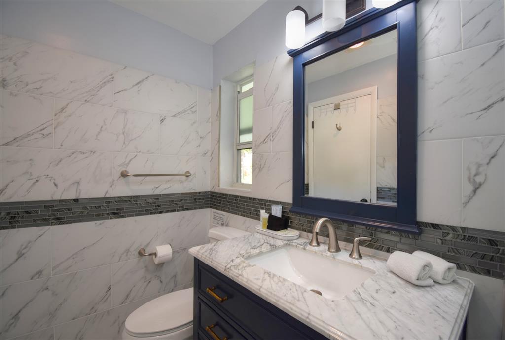 214 Southeast 5th Street Dania Beach, FL 33004 - Photo 43 of 50 a bathroom with a granite countertop sink and a mirror