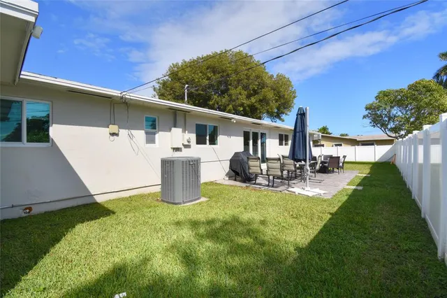 a view of a house with a yard porch and sitting area