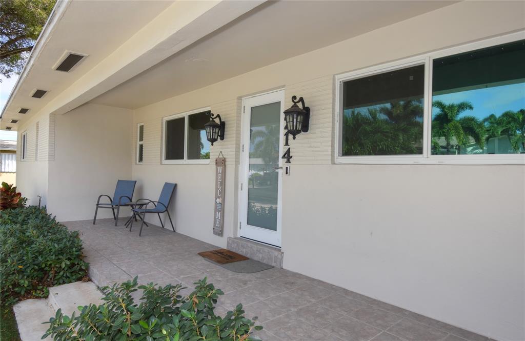 214 Southeast 5th Street Dania Beach, FL 33004 - Photo 5 of 50 a view of a porch with a table and chairs