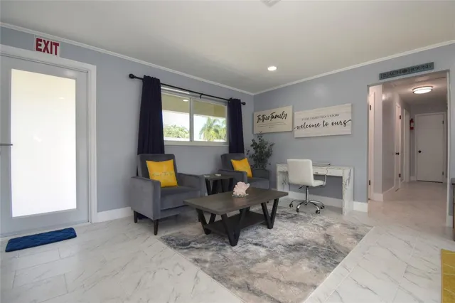 a living room with furniture a window and a table