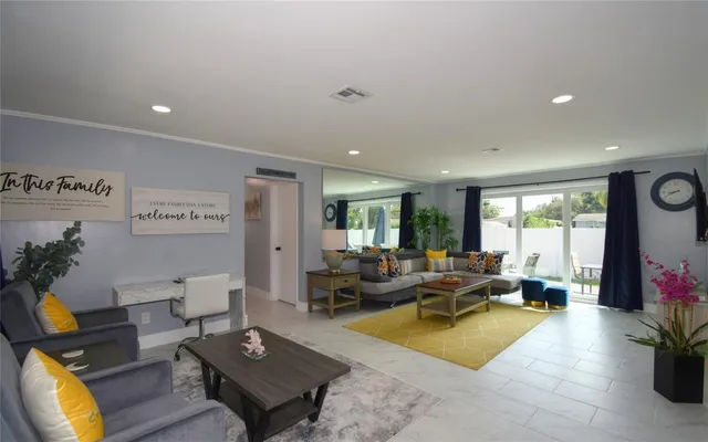 a living room with furniture pool table and a large window