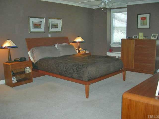 8800 Bickley Place Raleigh, NC 27613 - Photo 10 of 12 Master Bedroom with His/Her walk-in closets, ceiling fan, window seats, 2" blinds and TV niche Master Bedroom