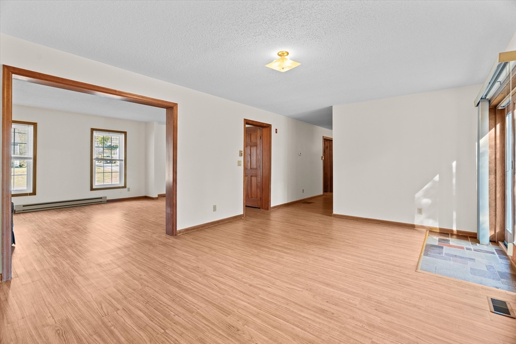 102 Valley Road Barre, MA 01005 - Photo 11 of 40 an empty room with wooden floor and windows