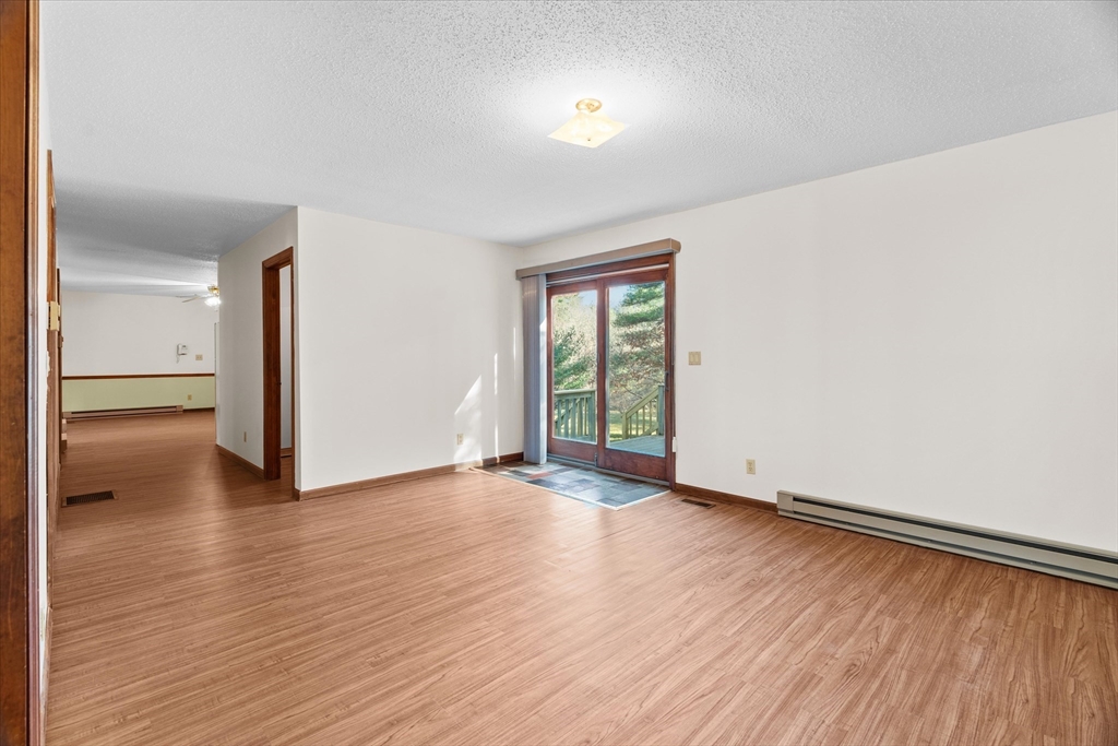 102 Valley Road Barre, MA 01005 - Photo 12 of 40 a view of an empty room with wooden floor and a window