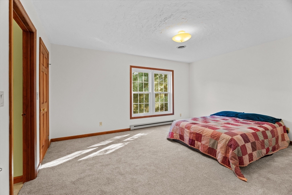 102 Valley Road Barre, MA 01005 - Photo 14 of 40 a bedroom with a bed and a window