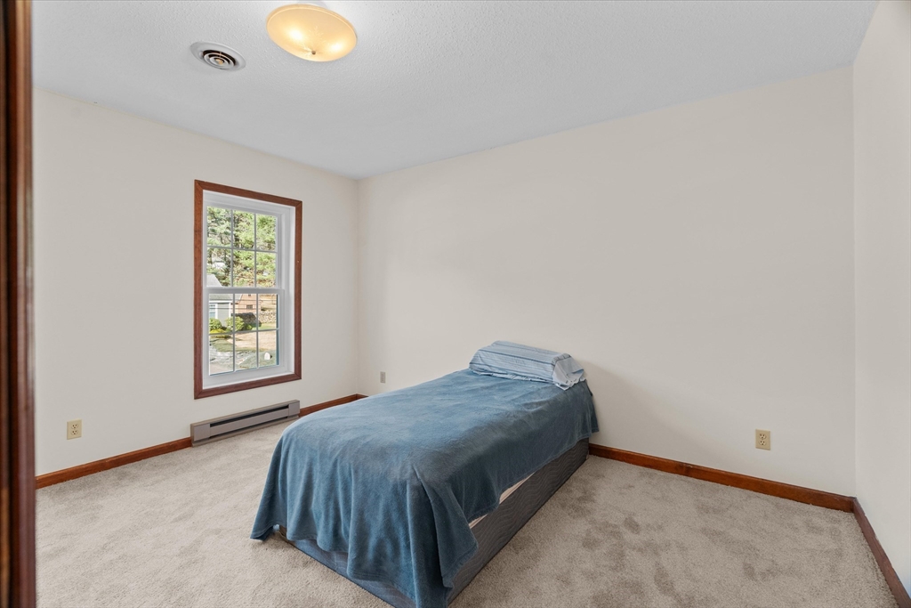 102 Valley Road Barre, MA 01005 - Photo 18 of 40 a bed sitting in a bedroom next to a window