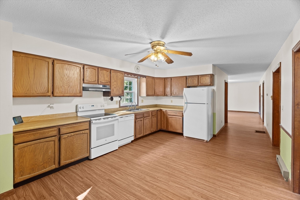 102 Valley Road Barre, MA 01005 - Photo 3 of 40 a kitchen with a sink a refrigerator and cabinets