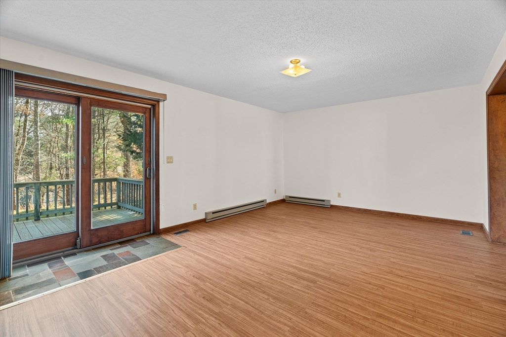 102 Valley Road Barre, MA 01005 - Photo 10 of 40 a view of an empty room with wooden floor and a window