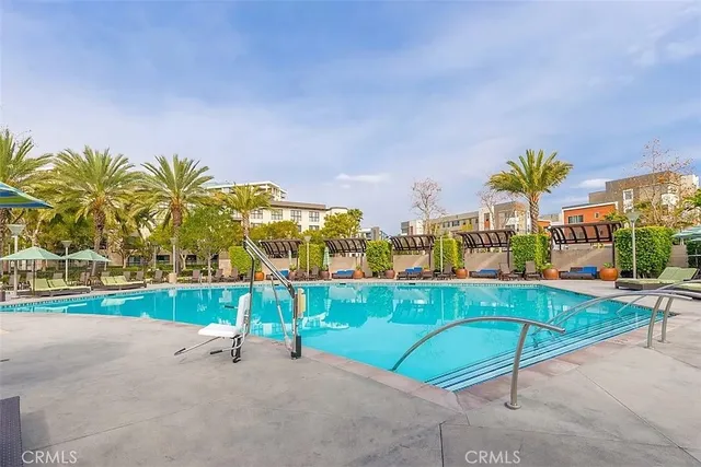 a view of a sign board with buildings in the background