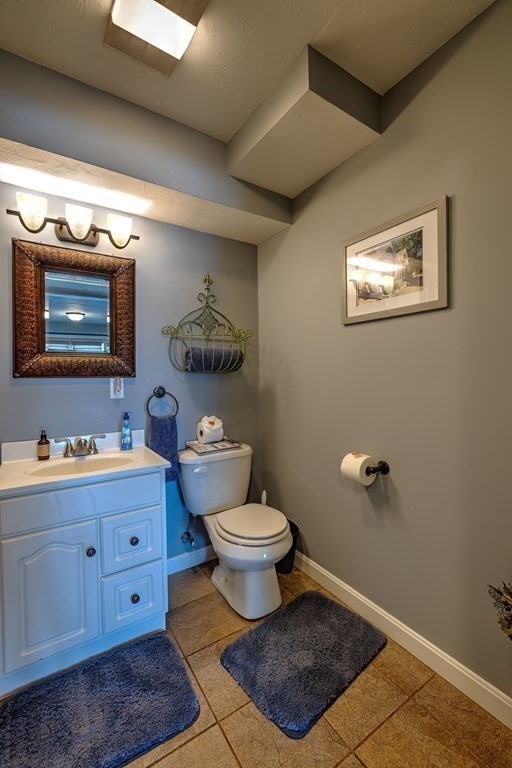 59 Lake Road Brookfield, MA 01506 - Photo 27 of 42 a bathroom with a toilet a sink and mirror