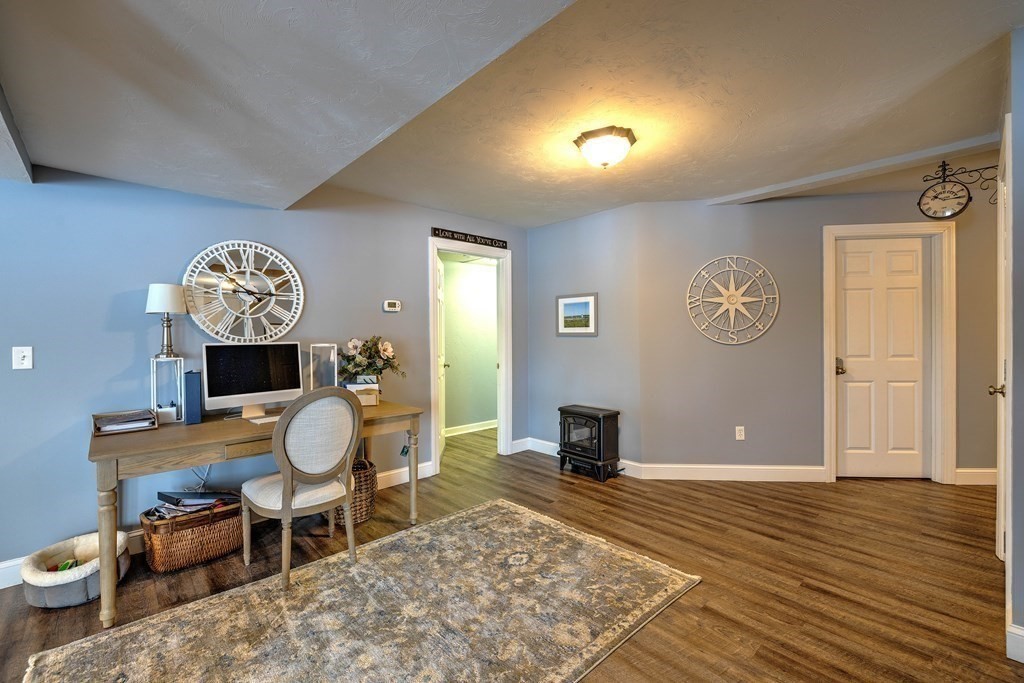 59 Lake Road Brookfield, MA 01506 - Photo 29 of 42 a living room with furniture a table and wooden floor